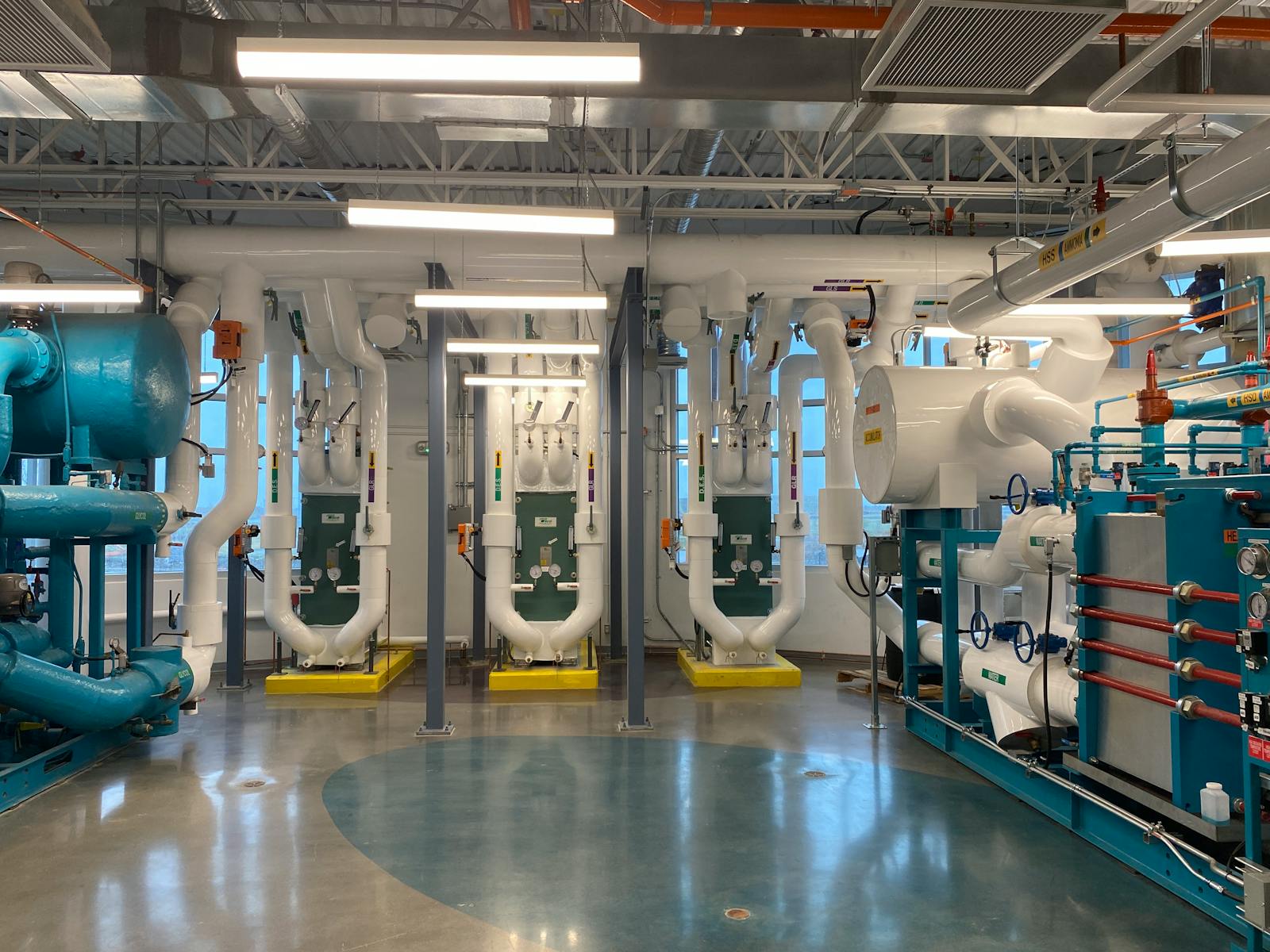 HVAC commissioning — commercial chiller plant with pumps, heat exchangers, and piping ready for sequence verification under ASHRAE Guideline 0