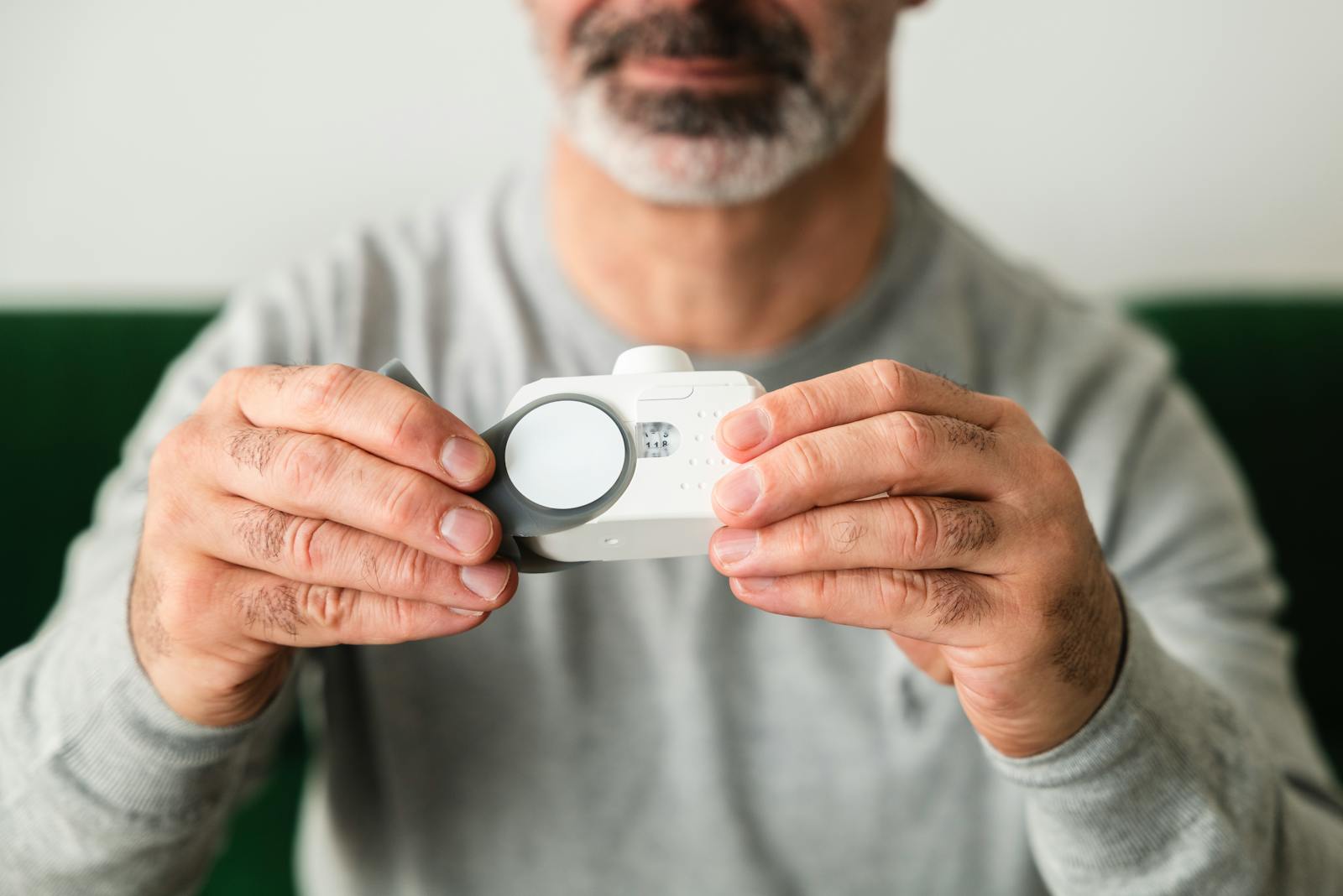 Indoor air quality testing — certified technician with a handheld CO2 and particulate monitor for ASHRAE 62.1 ventilation verification